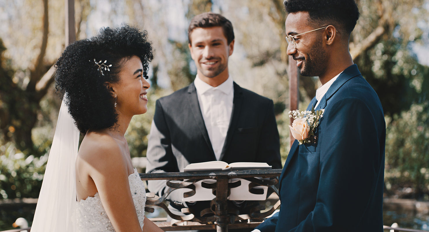 couple exchanging vows at an outdoor ceremony